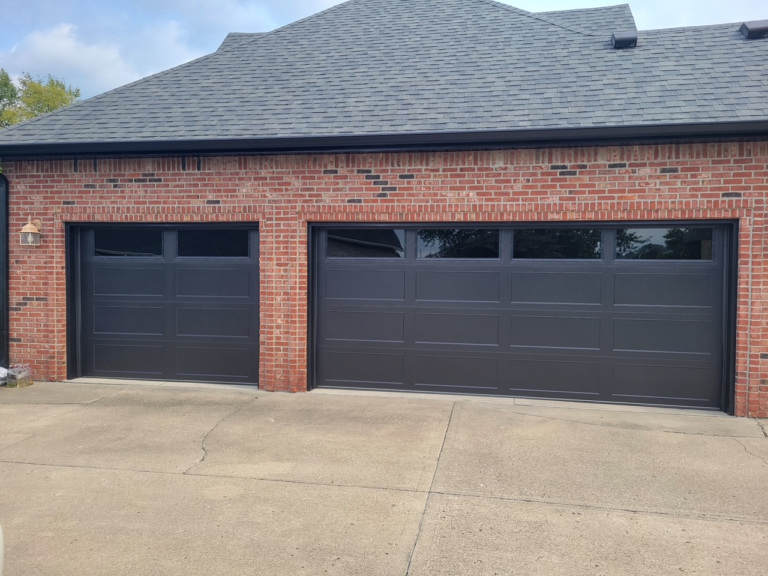 Long recessed panel insulated garage doors with tinted windows installed in Lebanon, Indiana